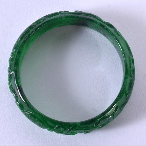 1720 - A CHINESE CARVED SPINACH JADE BANGLE 20th Century. 44.4 grams. 5.75 cm wide.