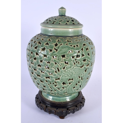 1721 - AN UNUSUAL 19TH CENTURY CHINESE CELADON RETICULATED VASE AND COVER Qing. 28 cm x 12 cm.