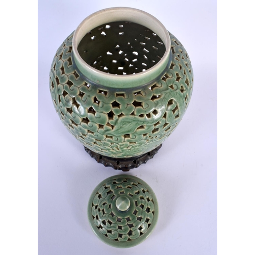 1721 - AN UNUSUAL 19TH CENTURY CHINESE CELADON RETICULATED VASE AND COVER Qing. 28 cm x 12 cm.