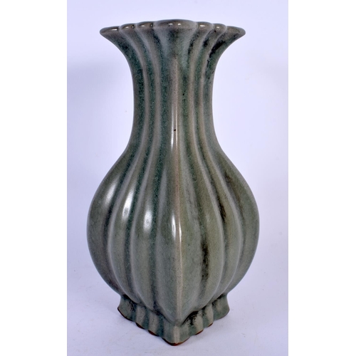 1725 - A CHINESE CELADON STONEWARE RIBBED VASE 20th Century. 23 cm high.