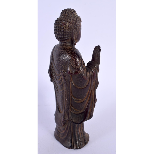 1769 - A CHINESE CARVED BUFFALO HORN TYPE FIGURE OF A STANDING BUDDHA 20th Century. 180 grams. 15 cm high.