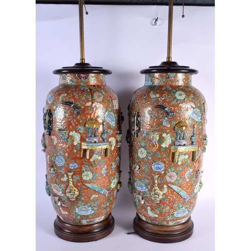 1794 - A VERY UNUSUAL PAIR OF 19TH CENTURY CHINESE CORAL GROUND PORCELAIN LAMPS bearing Chenghua marks to b... 