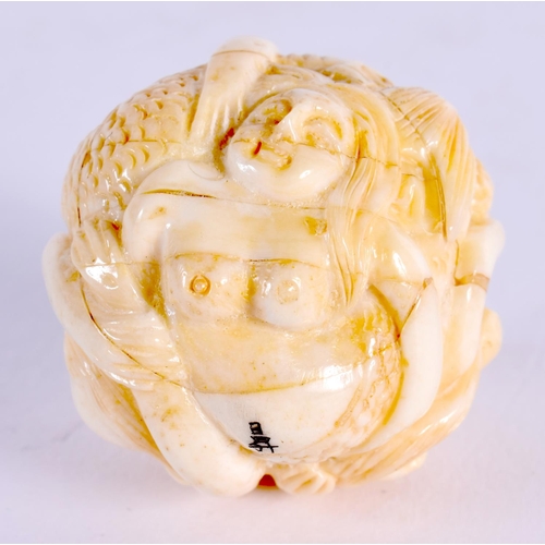 1865 - A JAPANESE CARVED BONE FIGURAL BALL. 37 grams. 3.5 cm wide.