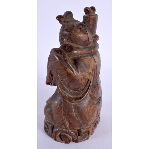 1881 - A 19TH CENTURY CHINESE CARVED HARDWOOD FIGURE OF AN IMMORTAL modelled in robes. 15 cm x 8 cm.