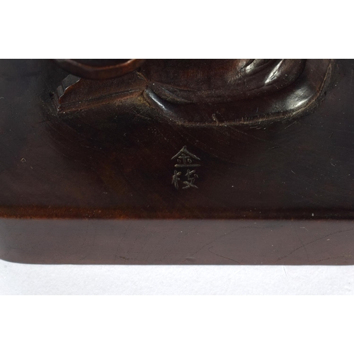 1909 - A VERY UNUSUAL 19TH CENTURY CHINESE CARVED HARDWOOD SEAL Qing, possibly Zitan, modelled as a seated ... 