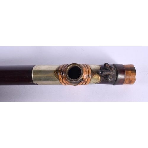 1921 - A 19TH CENTURY CHINESE CARVED RHINOCEROS HORN CAPPED OPIUM PIPE with lacquered body. 45 cm long.