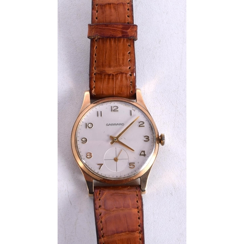 3000 - A 9CT GOLD GARRARD WRISTWATCH. 3.5 cm wide inc