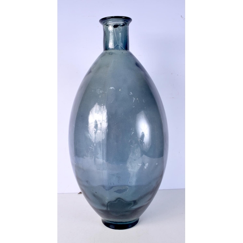 3005 - A large blue glass vase 59 cm.