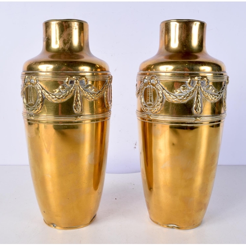 3014 - A pair of Arts and Crafts Brass vases embossed with ribbons and wreaths 26 cm (2)