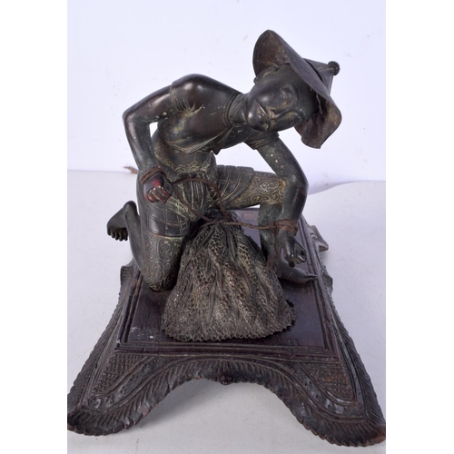 3060 - A 19th Century Japanese bronze figure of a field worker mounted on a carved wooden stand 11cm