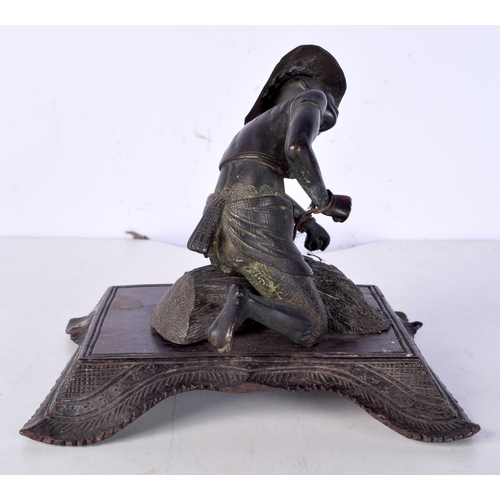 3060 - A 19th Century Japanese bronze figure of a field worker mounted on a carved wooden stand 11cm