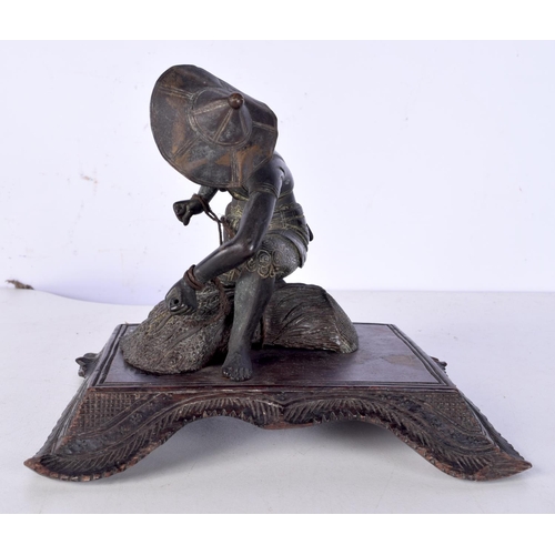 3060 - A 19th Century Japanese bronze figure of a field worker mounted on a carved wooden stand 11cm