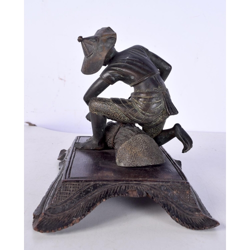 3060 - A 19th Century Japanese bronze figure of a field worker mounted on a carved wooden stand 11cm