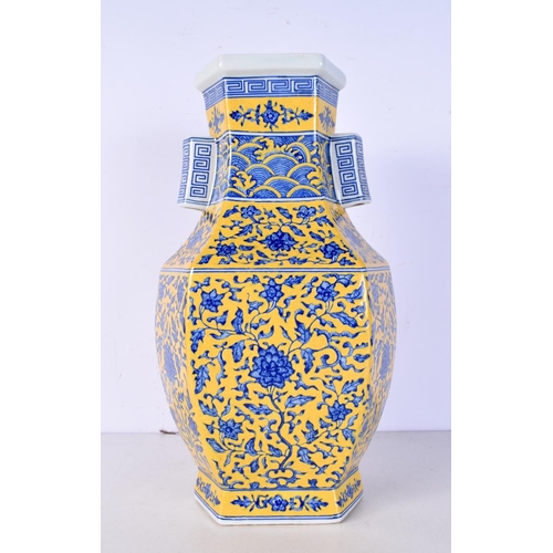 3116 - A Chinese porcelain Hexagonal sided yellow ground vase decorated in relief with foliage 37 cm.