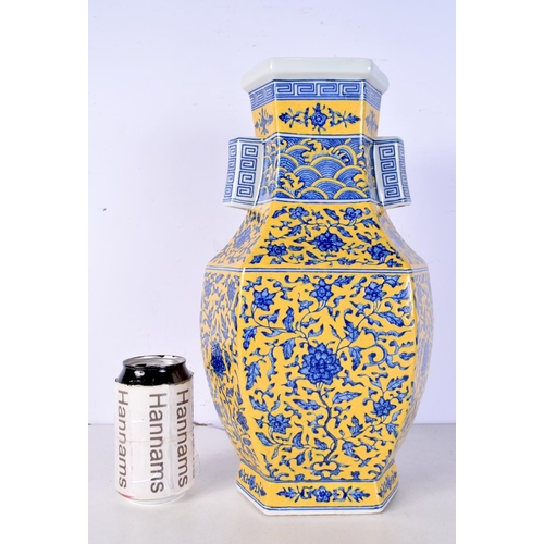 3116 - A Chinese porcelain Hexagonal sided yellow ground vase decorated in relief with foliage 37 cm.