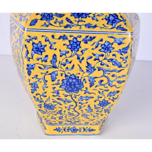 3116 - A Chinese porcelain Hexagonal sided yellow ground vase decorated in relief with foliage 37 cm.