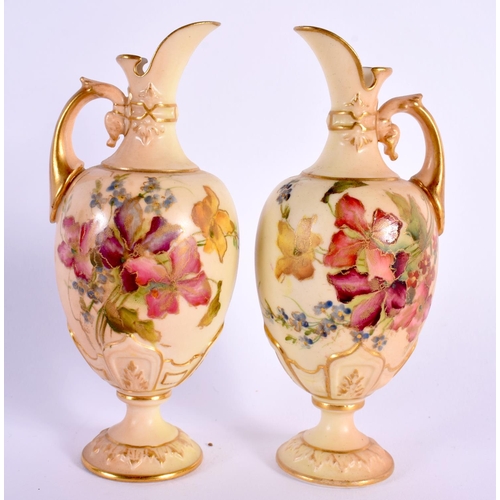 110 - Royal Worcester rare pair of miniature ewers painted with flowers on a blush ivory ground date mark ... 