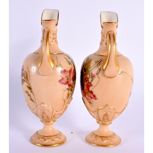 110 - Royal Worcester rare pair of miniature ewers painted with flowers on a blush ivory ground date mark ... 