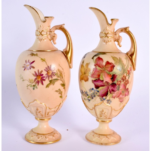 110 - Royal Worcester rare pair of miniature ewers painted with flowers on a blush ivory ground date mark ... 