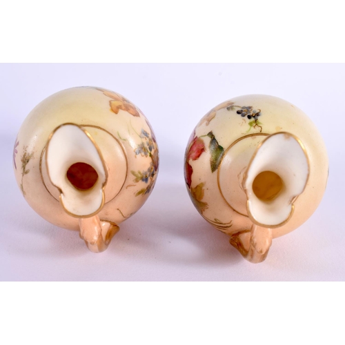 110 - Royal Worcester rare pair of miniature ewers painted with flowers on a blush ivory ground date mark ... 