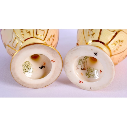 110 - Royal Worcester rare pair of miniature ewers painted with flowers on a blush ivory ground date mark ... 