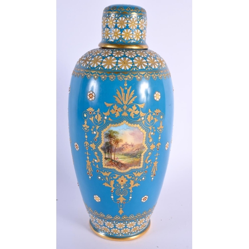 127 - Coalport jewelled bottle vase and cap cover painted with a landscape in a gilt panel and gilt and wh... 