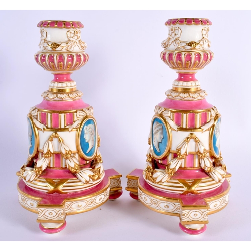 133 - Minton rare pair of candlesticks in Sevres style, painted with busts in medallions on a rose pompado... 