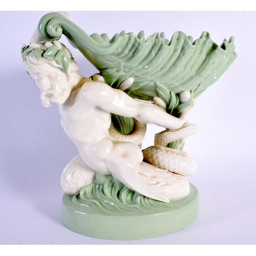 137 - Minton porcelain celadon shell dish, the shell supported by a sea god, impressed marks 21.5x23cm