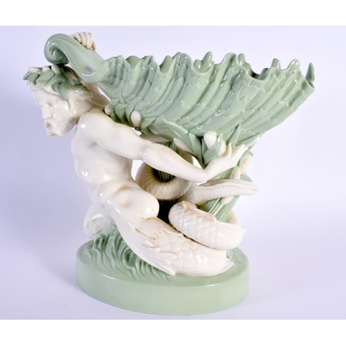 137 - Minton porcelain celadon shell dish, the shell supported by a sea god, impressed marks 21.5x23cm