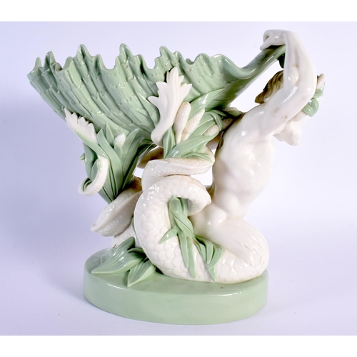 137 - Minton porcelain celadon shell dish, the shell supported by a sea god, impressed marks 21.5x23cm