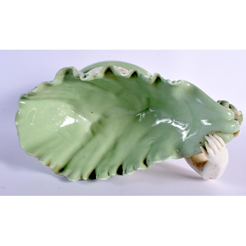 137 - Minton porcelain celadon shell dish, the shell supported by a sea god, impressed marks 21.5x23cm