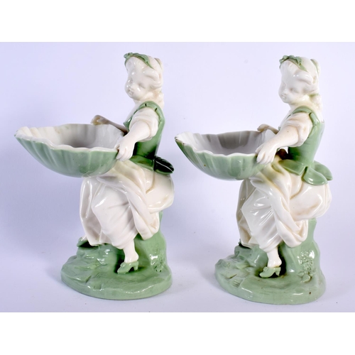 138 - Minton porcelain celadon pair of sweetmeat or bonbon dish figures, depicted as a seated maiden holdi... 