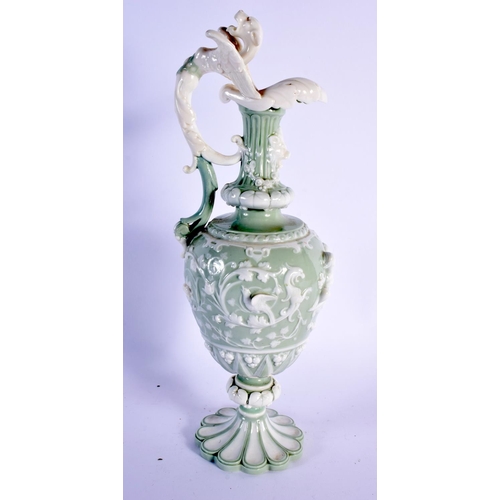 140 - Minton porcelain celadon pedestal ewer of oviform with raised neck, foliate spout, the handle formed... 