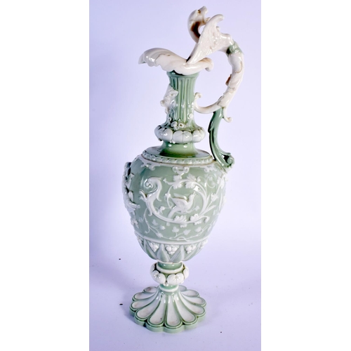 140 - Minton porcelain celadon pedestal ewer of oviform with raised neck, foliate spout, the handle formed... 