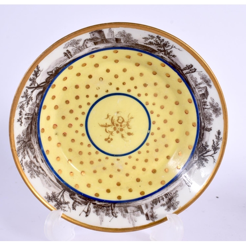 167 - Sevres coffee can and stand with gilded dots on a pale yellow ground painted with an en grisaille la... 