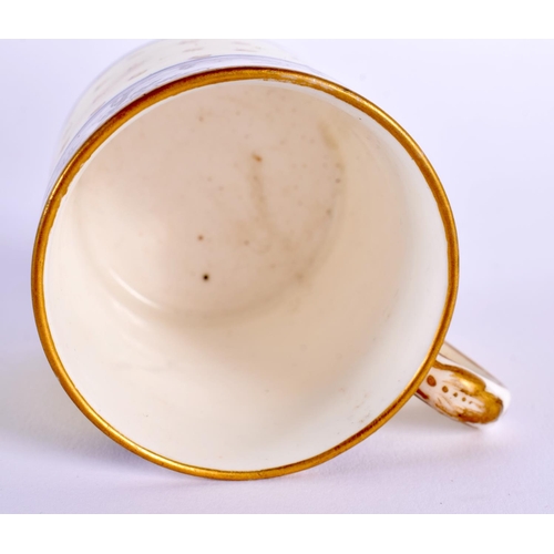 167 - Sevres coffee can and stand with gilded dots on a pale yellow ground painted with an en grisaille la... 