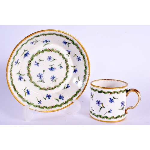 172 - Sevres small coffee can and stand painted with cornflowers and chains of berried leaves,  Crossed L... 