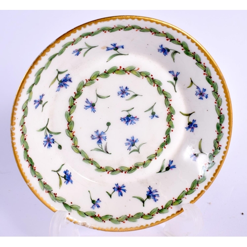 172 - Sevres small coffee can and stand painted with cornflowers and chains of berried leaves,  Crossed L... 