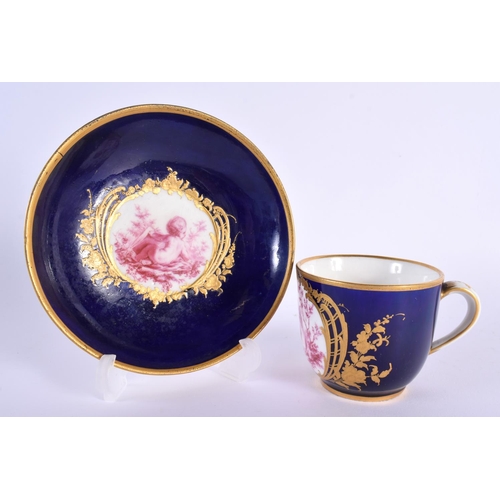 177 - Sevres blue ground cup and saucer painted in puce with children surrounded by gilt flowers, crossed ... 