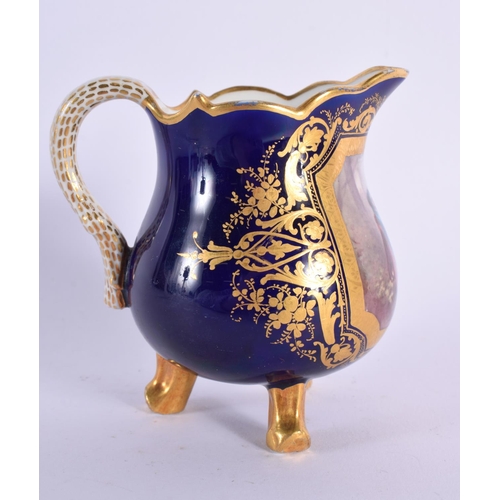 180 - Sevres three footed cream jug with cobalt blue ground painted with a courting couple in an elaborate... 