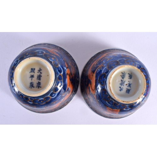 209 - A PAIR OF 19TH CENTURY CHINESE CORAL DRAGON BLUE AND WHITE TEABOWLS bearing Kangxi marks to base, to... 