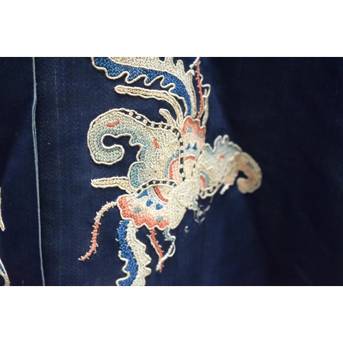 210 - A LATE 19TH CENTURY CHINESE SILK EMBROIDERED MIDNIGHT BLUE ROBE Qing, decorated with butterflies and... 