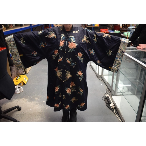 210 - A LATE 19TH CENTURY CHINESE SILK EMBROIDERED MIDNIGHT BLUE ROBE Qing, decorated with butterflies and... 