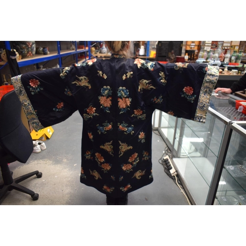 210 - A LATE 19TH CENTURY CHINESE SILK EMBROIDERED MIDNIGHT BLUE ROBE Qing, decorated with butterflies and... 