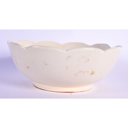 216 - A CHINESE QING DYNASTY DING STYLE CREAM GLAZED BOWL elegantly modelled with a lotus type flower inte... 