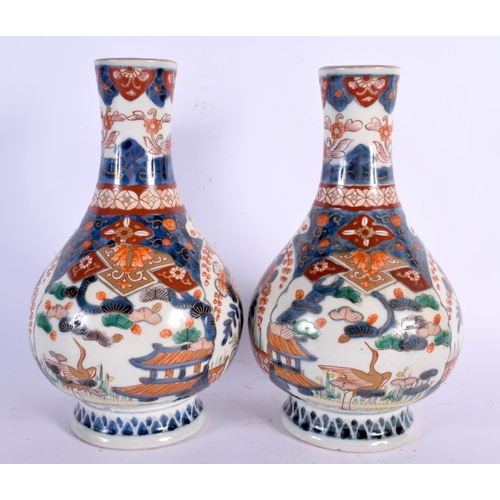 256 - A PAIR OF 18TH CENTURY JAPANESE EDO PERIOD IMARI VASES painted with landscapes. 24 cm x 11 cm.