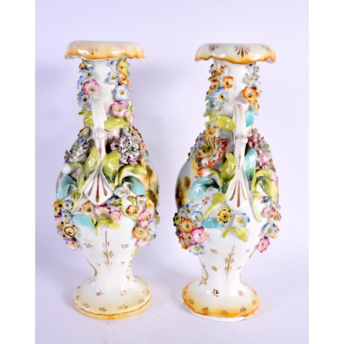 26 - A PAIR OF EARLY 19TH CENTURY ENGLISH TWIN HANDLED VASES painted with buildings. 27 cm high.