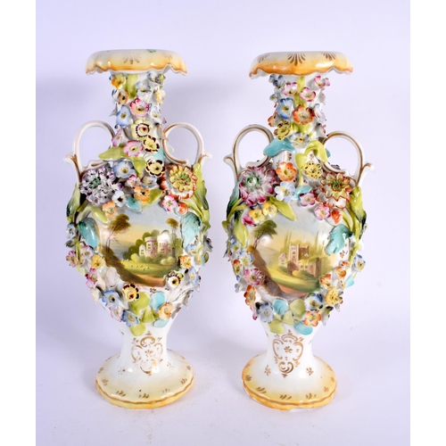 26 - A PAIR OF EARLY 19TH CENTURY ENGLISH TWIN HANDLED VASES painted with buildings. 27 cm high.