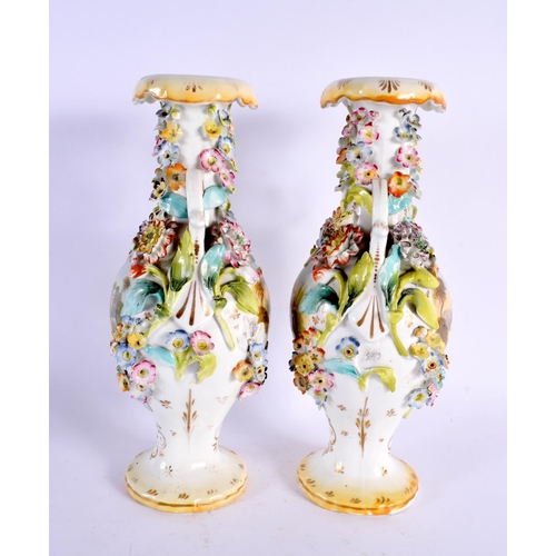 26 - A PAIR OF EARLY 19TH CENTURY ENGLISH TWIN HANDLED VASES painted with buildings. 27 cm high.