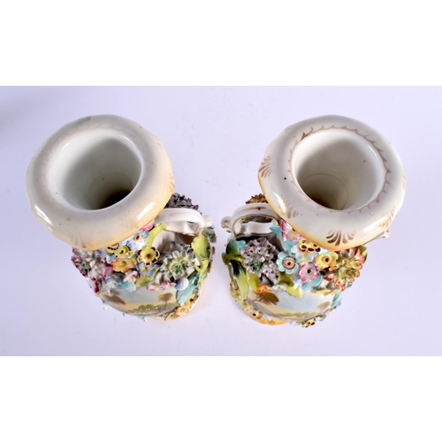 26 - A PAIR OF EARLY 19TH CENTURY ENGLISH TWIN HANDLED VASES painted with buildings. 27 cm high.